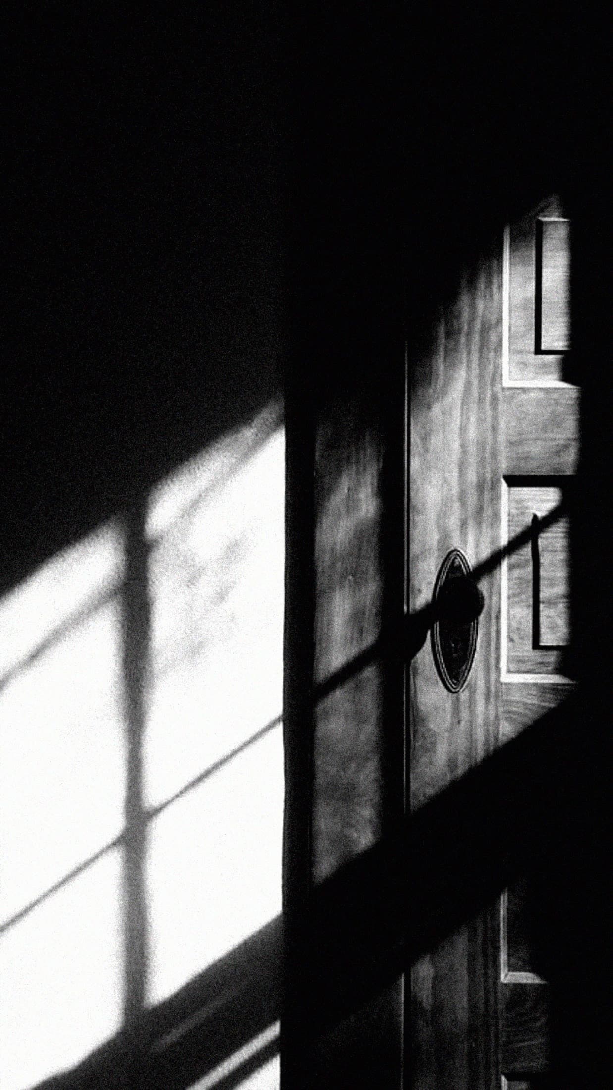 Window light falling through a half-open door