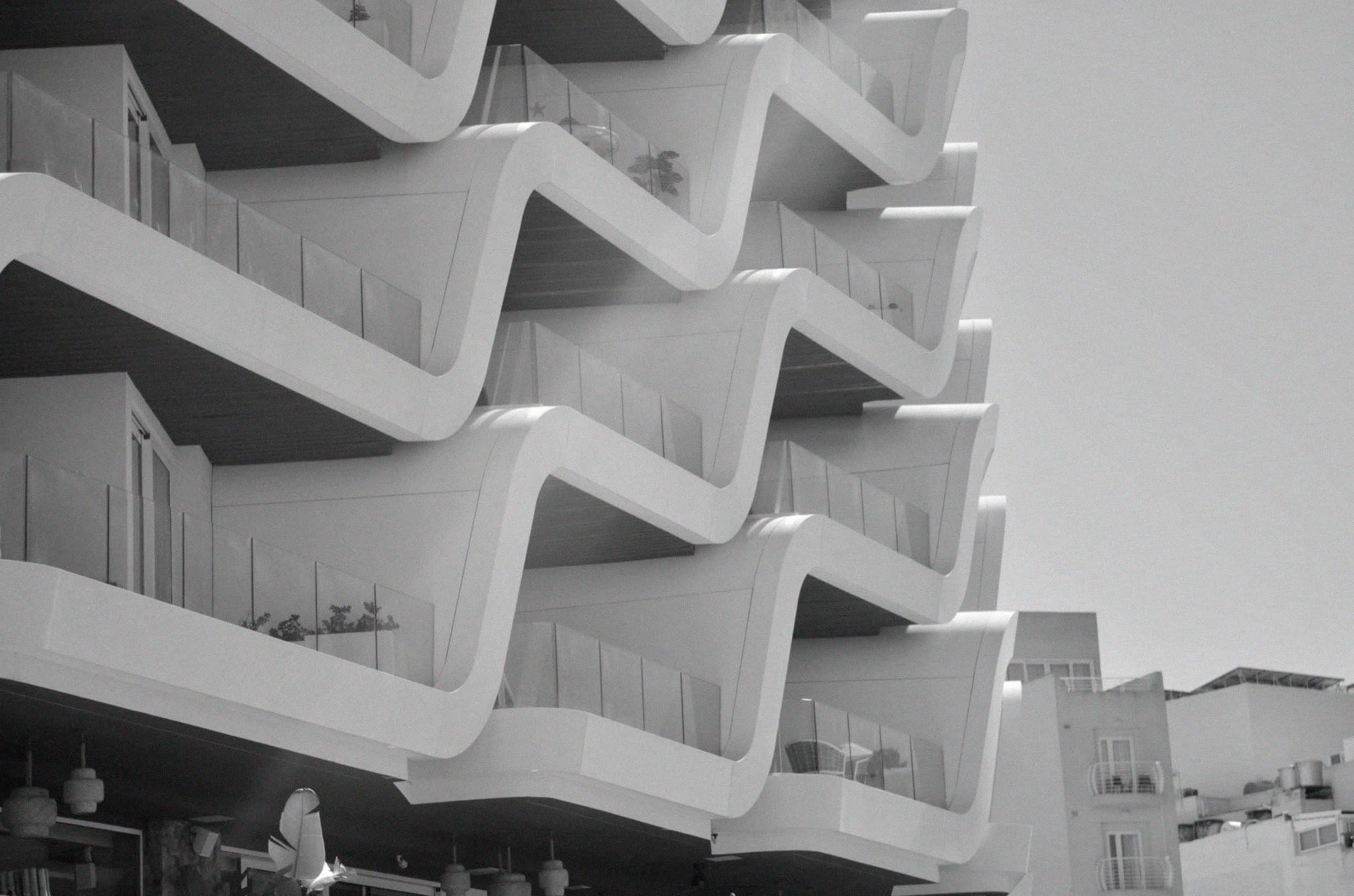 Curved balconies repeating up a white building