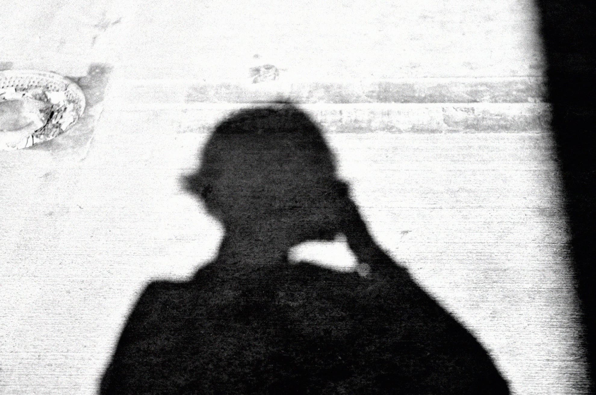 The shadow of a photographer holding a camera